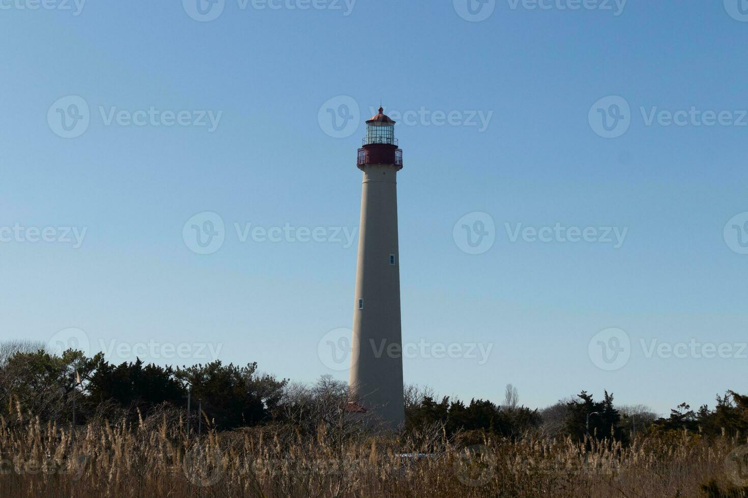 This is the Cape May point lighthouse located in the southernmost tip of New Jersey. This beacon of hope stands tall to help prevent sailors from wrecking and also letting them know where they are. photo