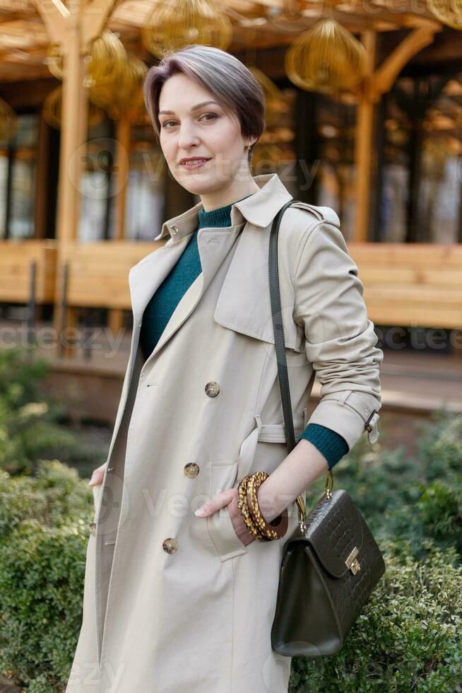 Portrait shooting of a attractive stylish short cut woman, Beige shades. photo