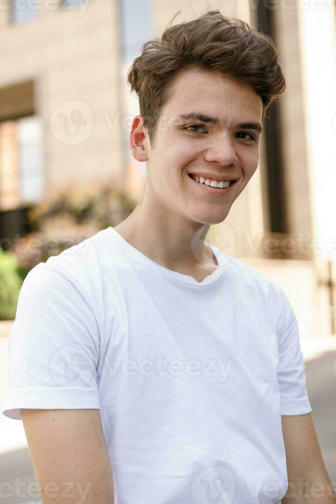 Handsome young hipster stylish man in white shirt, black pants photo