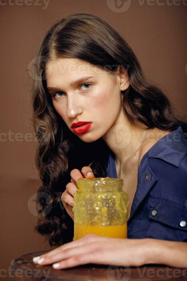 Girl with jar of honey. Healthy food concept, diet, dessert photo