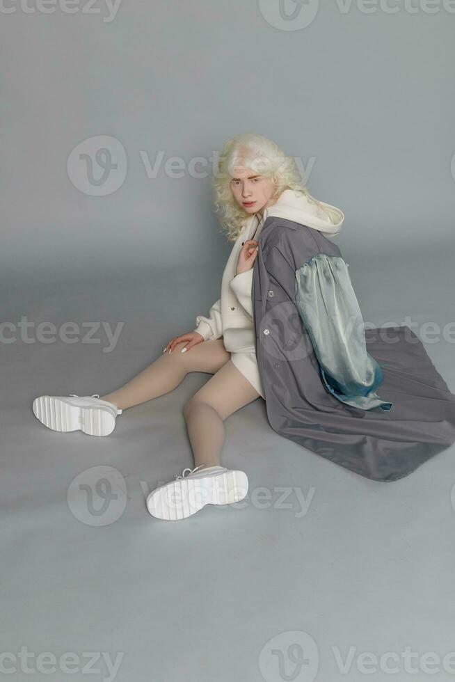 beautiful albino girl with white skin, natural lips and white hair photo