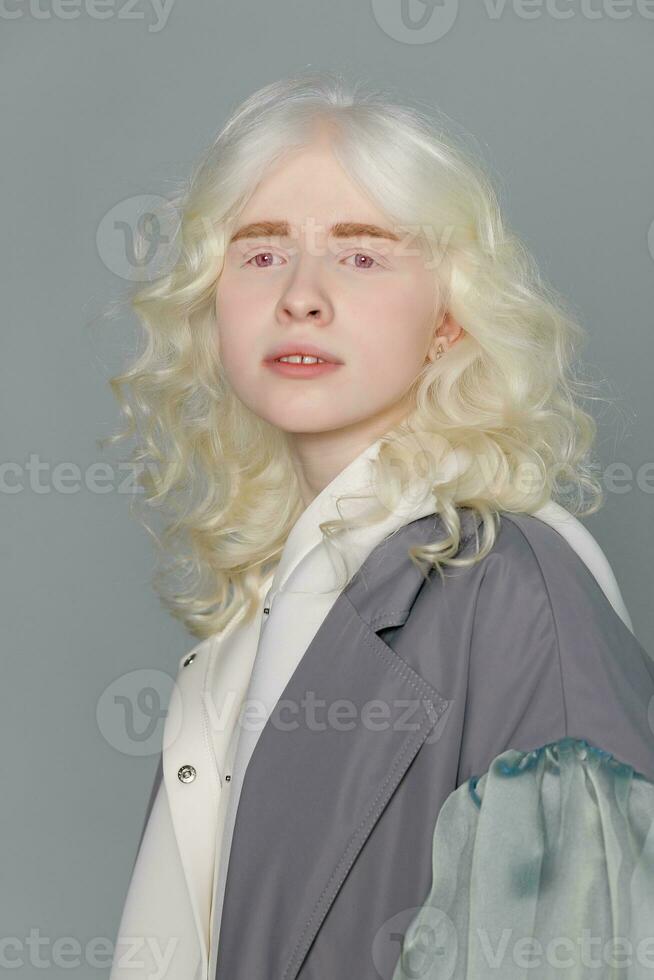 beautiful albino girl with white skin, natural lips and white hair photo