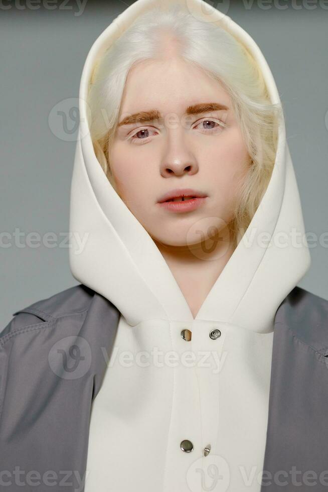 beautiful albino girl with white skin, natural lips and white hair photo