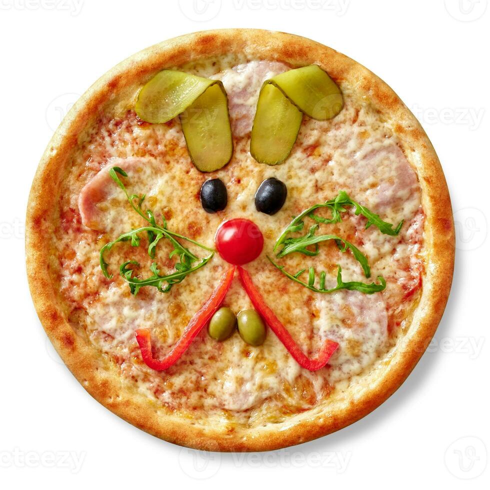 Kids pizza with ham, mozzarella and funny rabbit muzzle of cherry tomato, bell pepper, olives, arugula and pickled cucumber photo