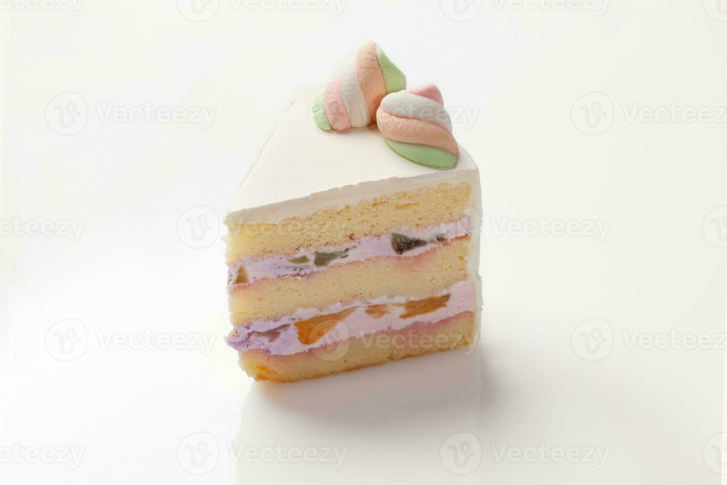 Slice of sponge cake with mascarpone cream, fruits and marshmallow photo