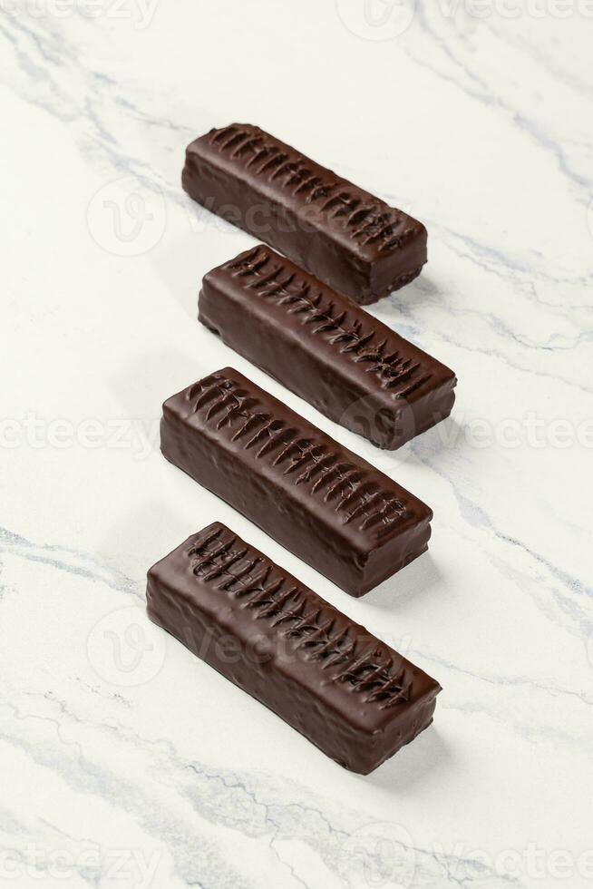 Chocolate bars without sugar stuffed with dried fruits and nuts photo