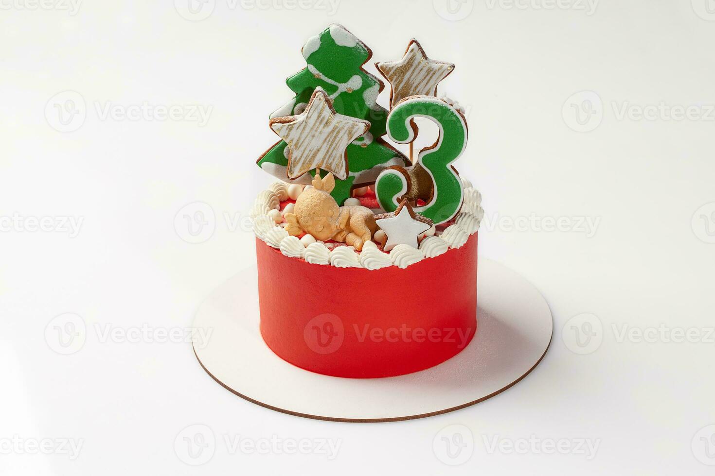 Cake with red icing decorated with figurine and shaped gingerbread photo