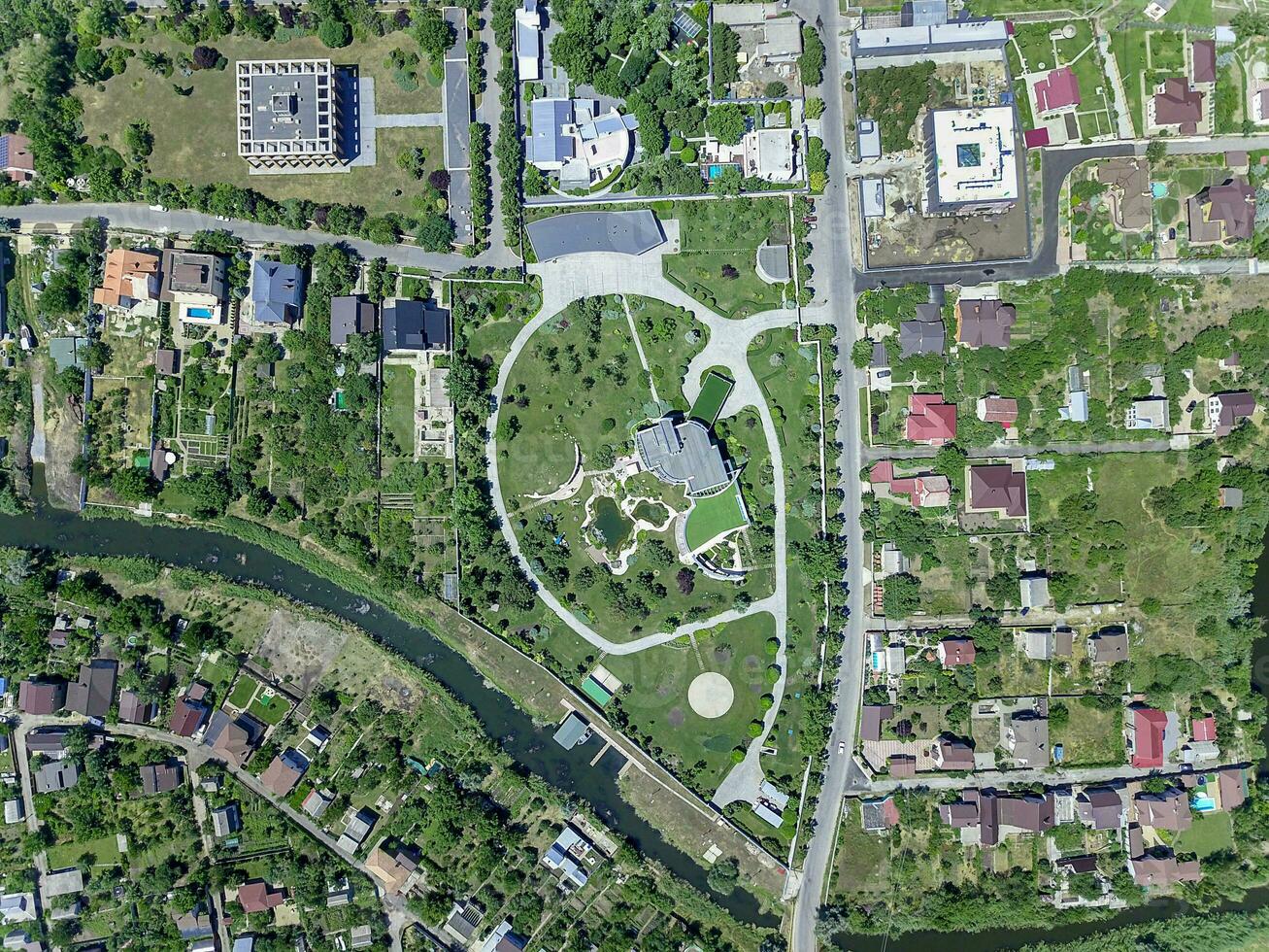 Aerial view of green suburban area with private residential buildings on river banks photo