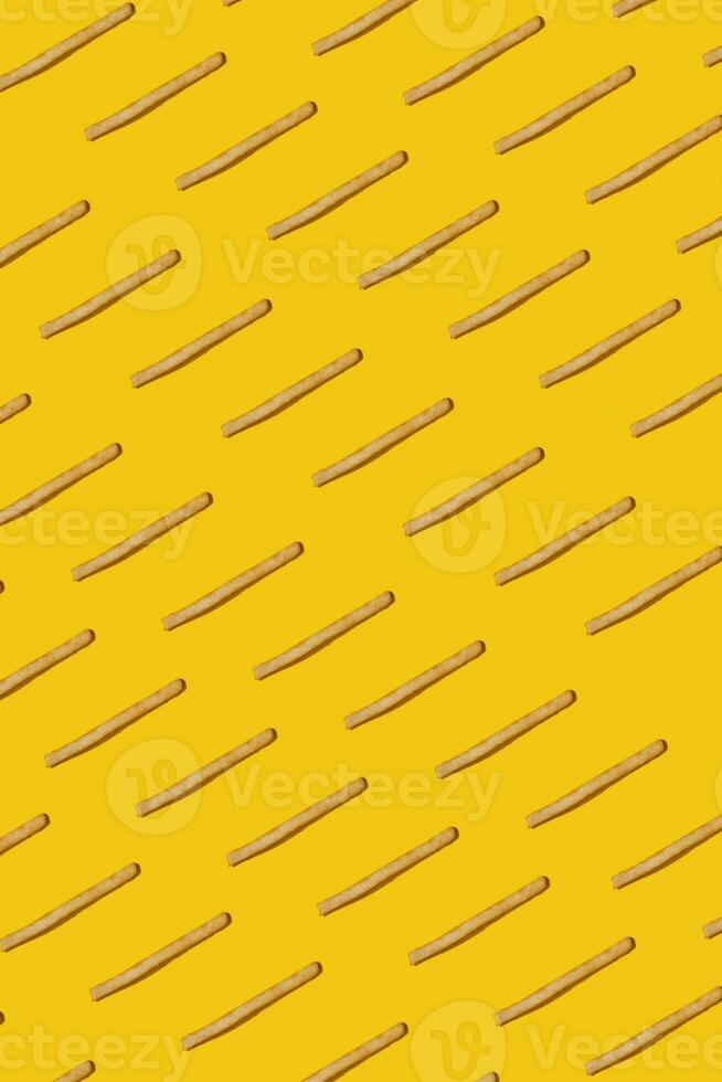 Heap of french fries on yellow background, top view photo