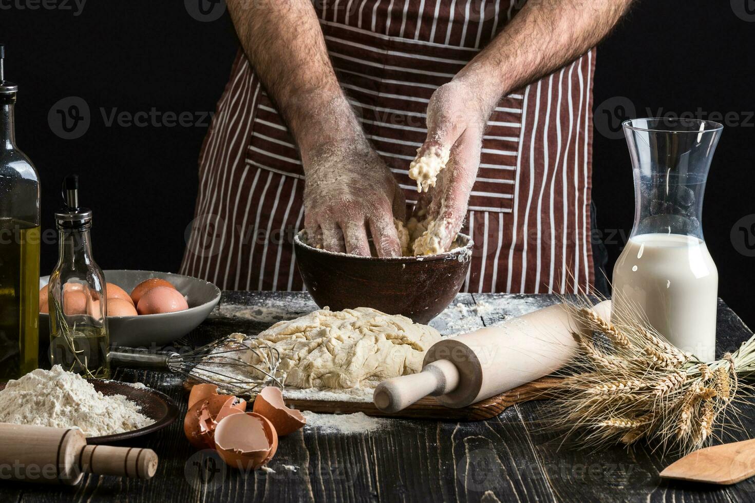 Against the background of men's hands knead the dough. Ingredients for cooking flour products or dough bread, muffins, pie, pizza dough . photo