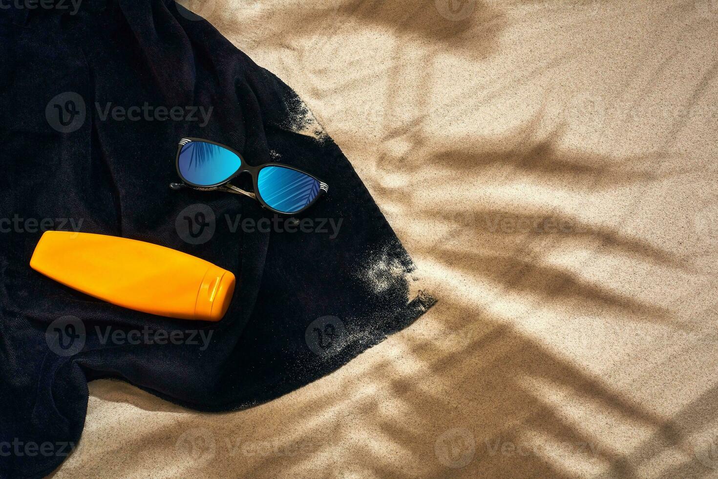 Top view of summer accessories on sandy beach photo