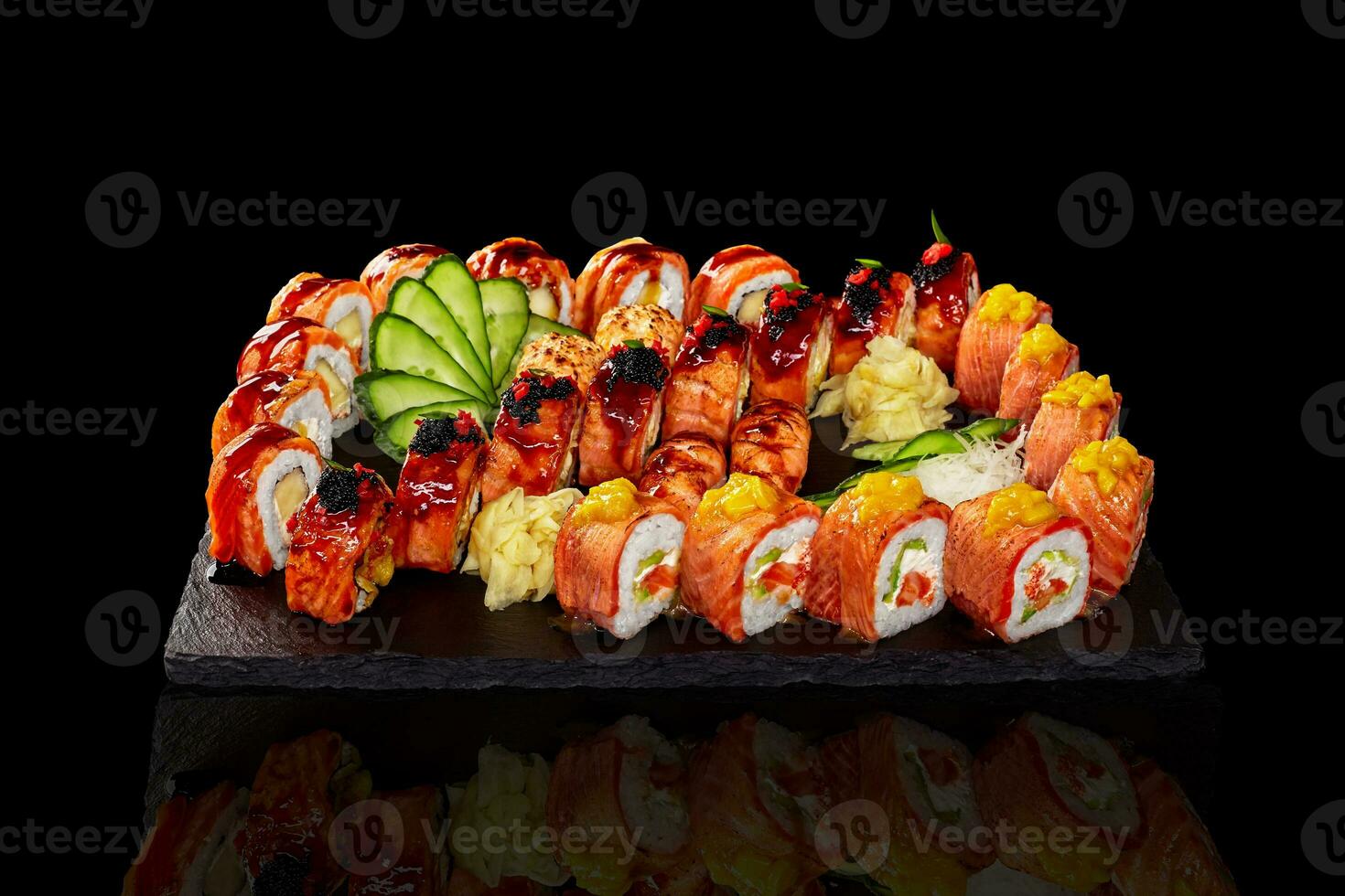 Set of rolls, nigiri sushi and gunkan maki with salmon on black background photo