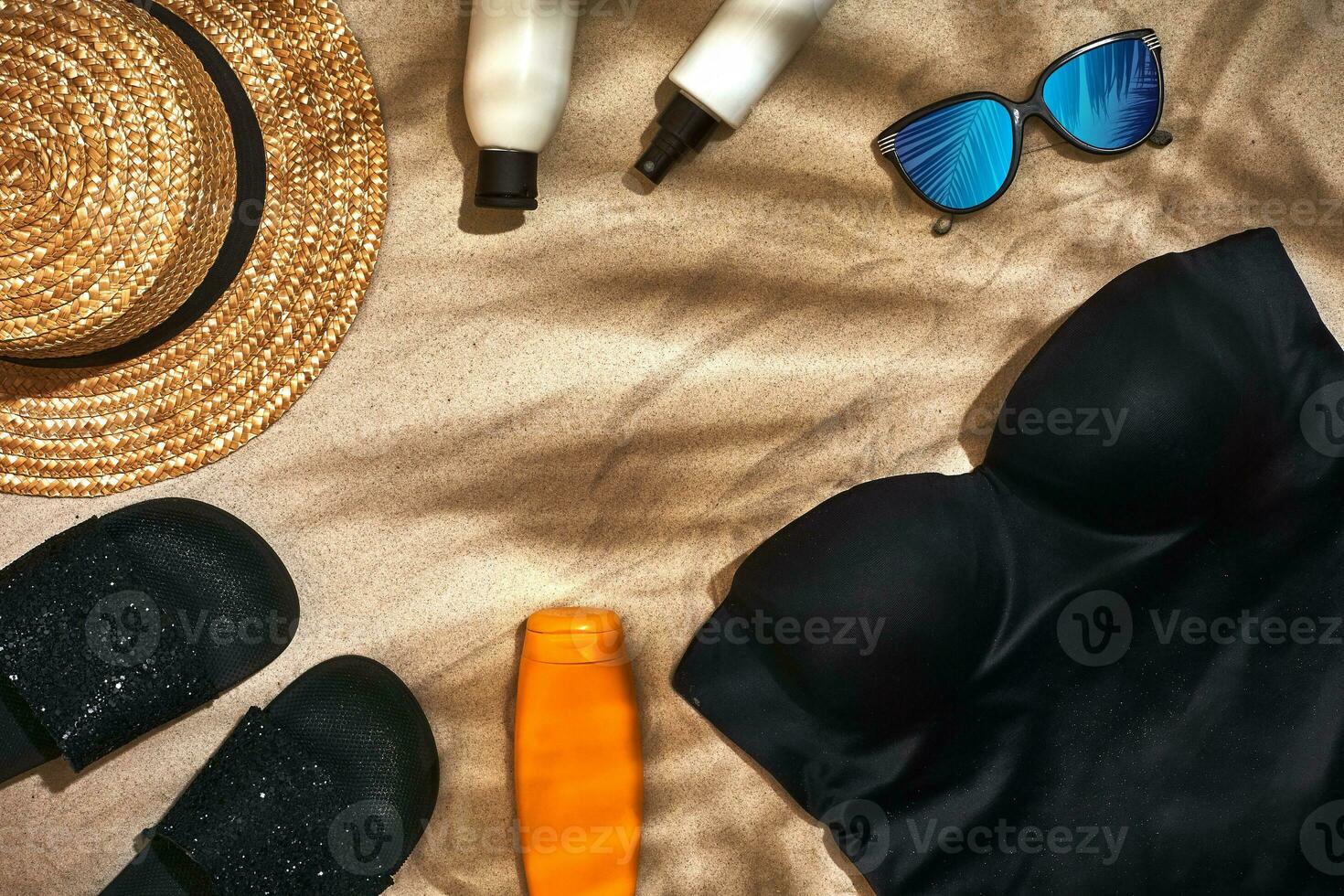 Summer background with straw hat, sunglasses, sunscreen bottle and flip flops photo