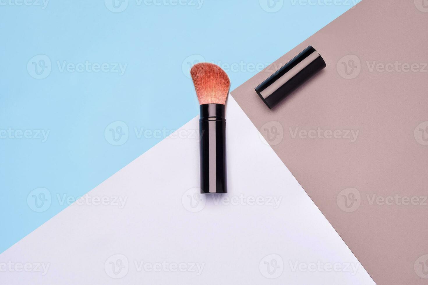 Makeup powder brush on colorful background photo