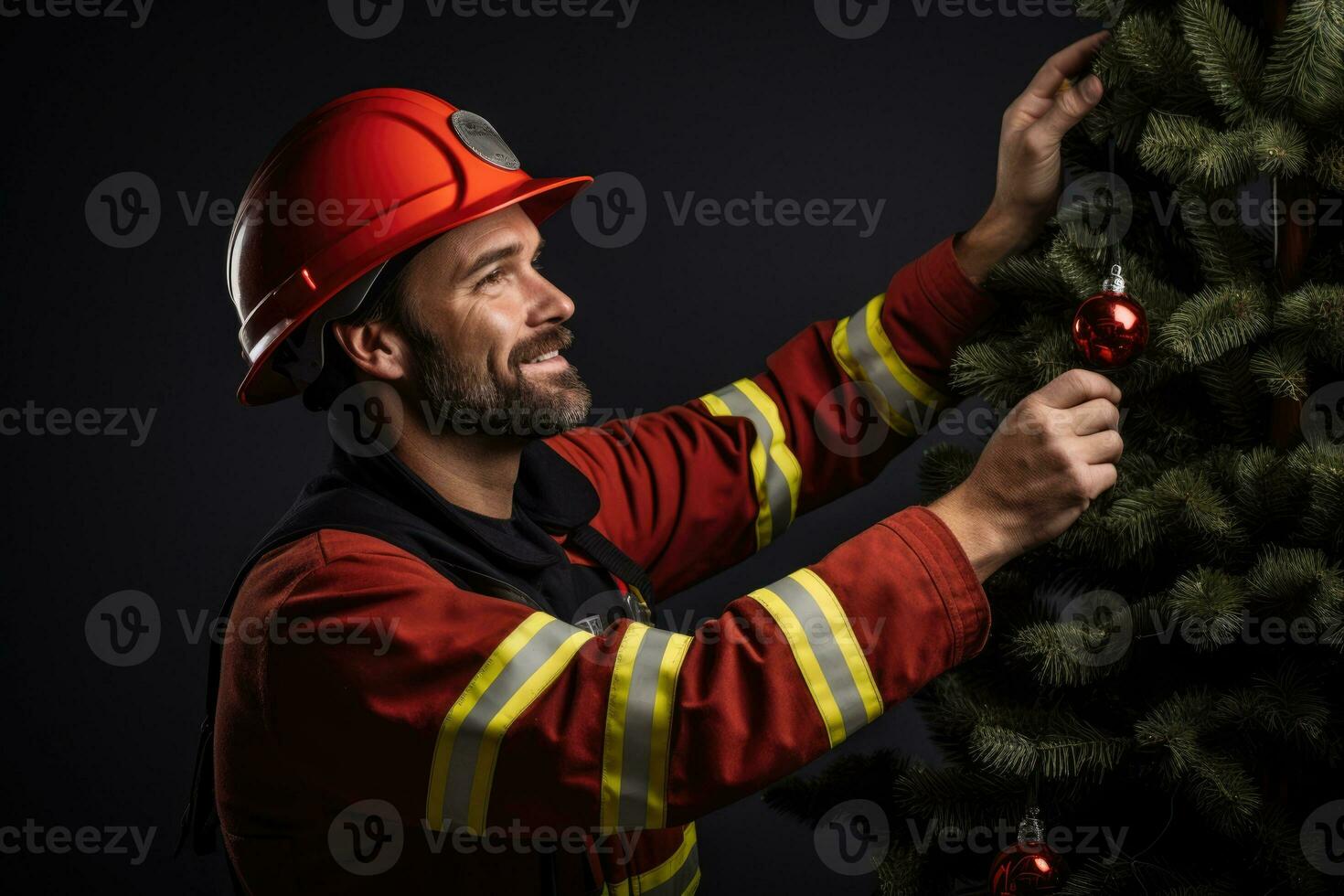A firefighter in New Years uniform decorating a Christmas tree isolated on a gradient background photo