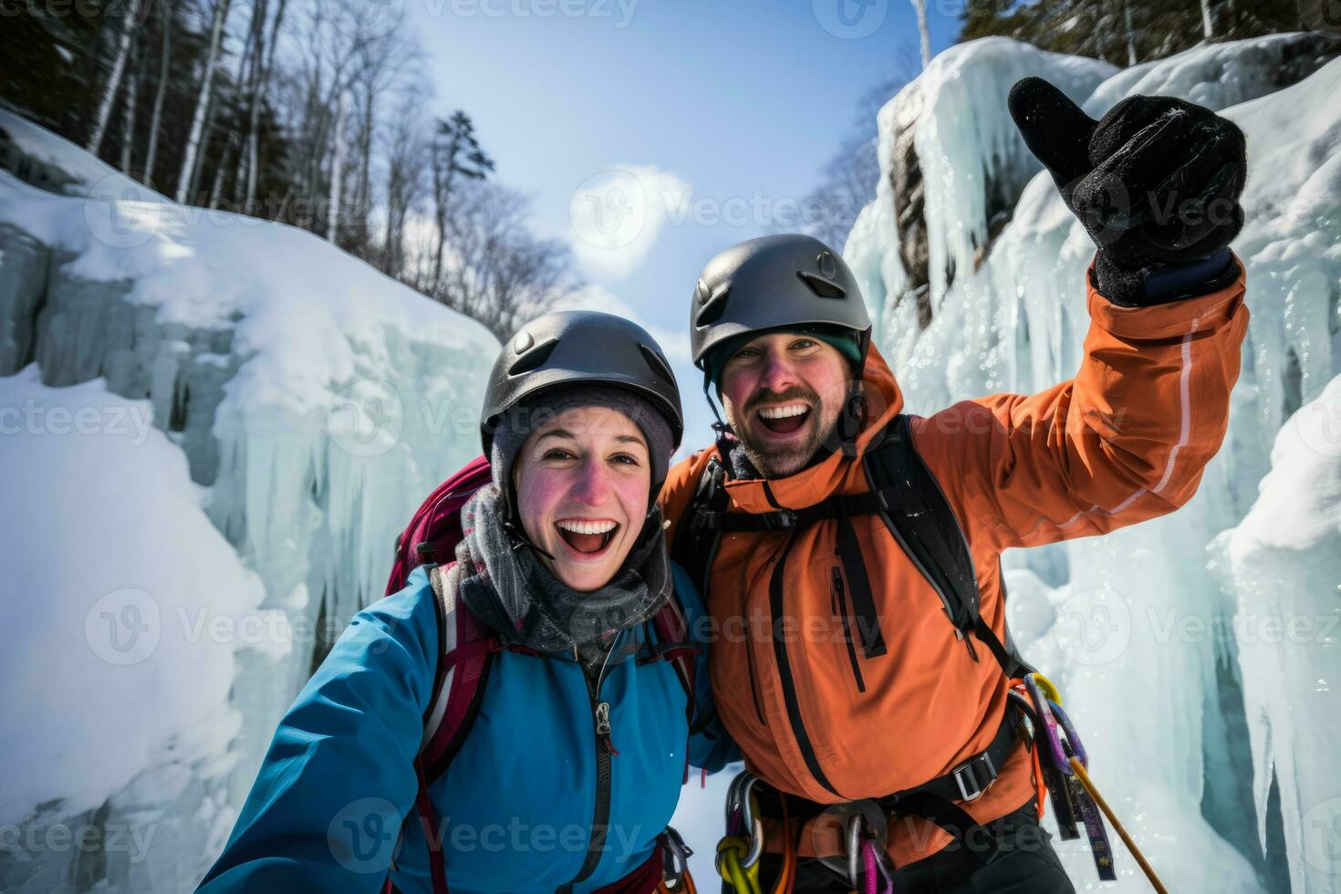 Thrilled couple conquering a shimmering frozen waterfall during exhilarating ice climb photo