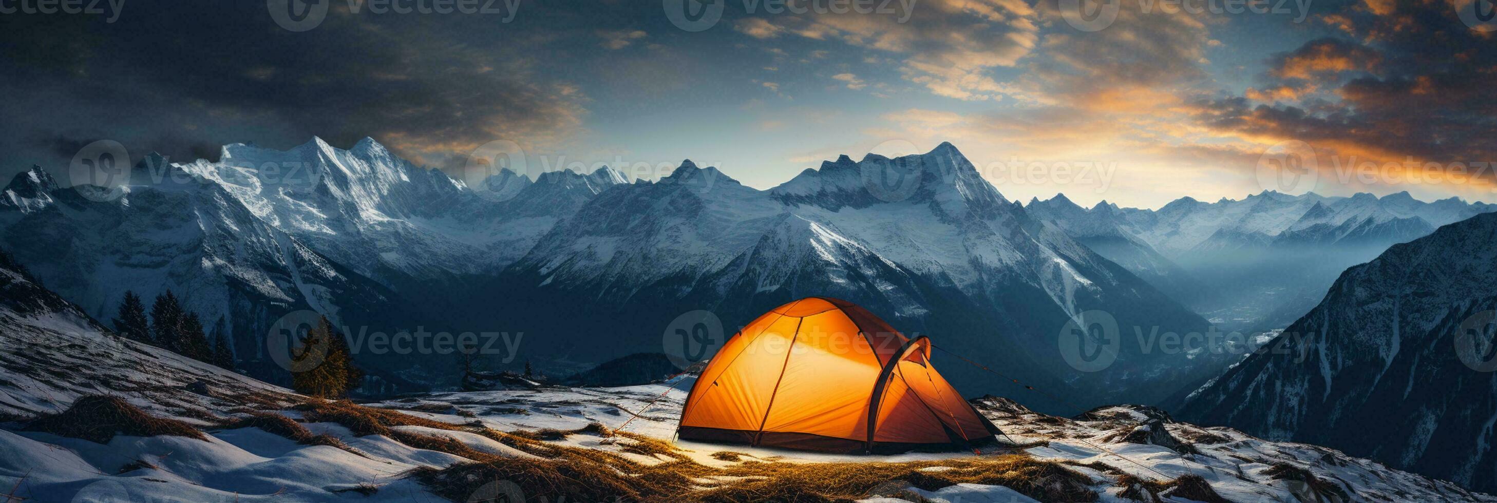 Tent nestled in snowy mountain landscape under a starlit sky photo