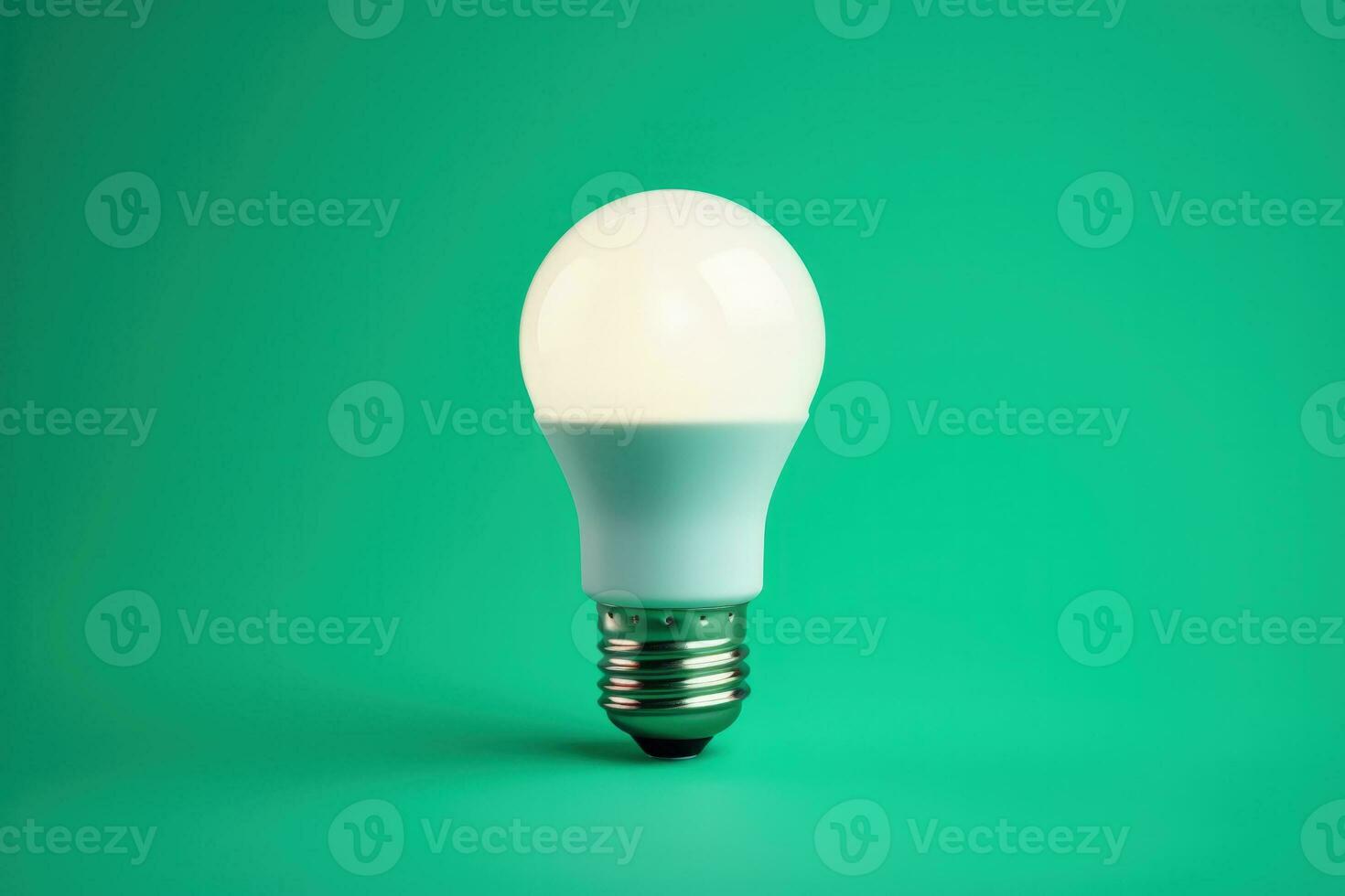 Efficient LED lightbulb glowing isolated on a gradient blue background photo