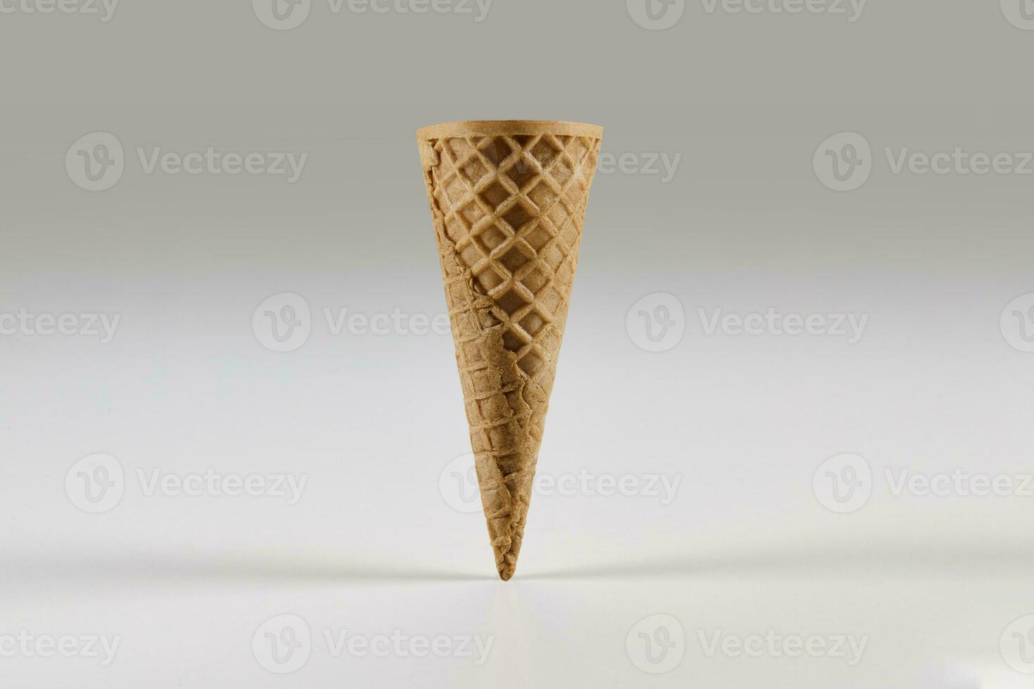 Empty medium wafer cone for ice cream isolated on white. Concept of food, treats. Mockup, template for your advertising and design. Close up photo