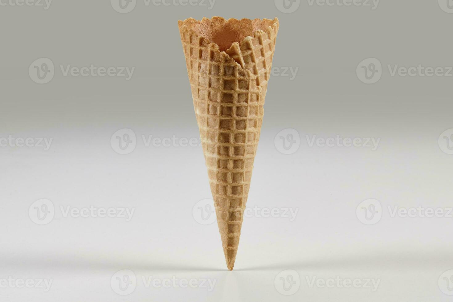 Empty, crispy wafer cone for ice cream isolated on white. Concept of food, treats. Mockup, template for your advertising and design. Close up photo