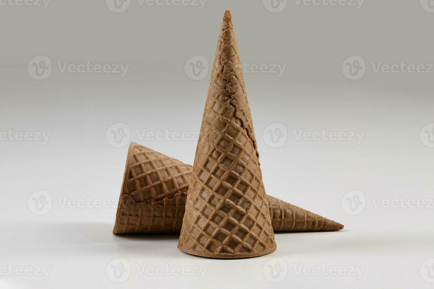 Two empty, big, chocolate wafer cones for ice cream isolated on white. Concept of food, treats. Mockup, template for advertising and design. Close up photo