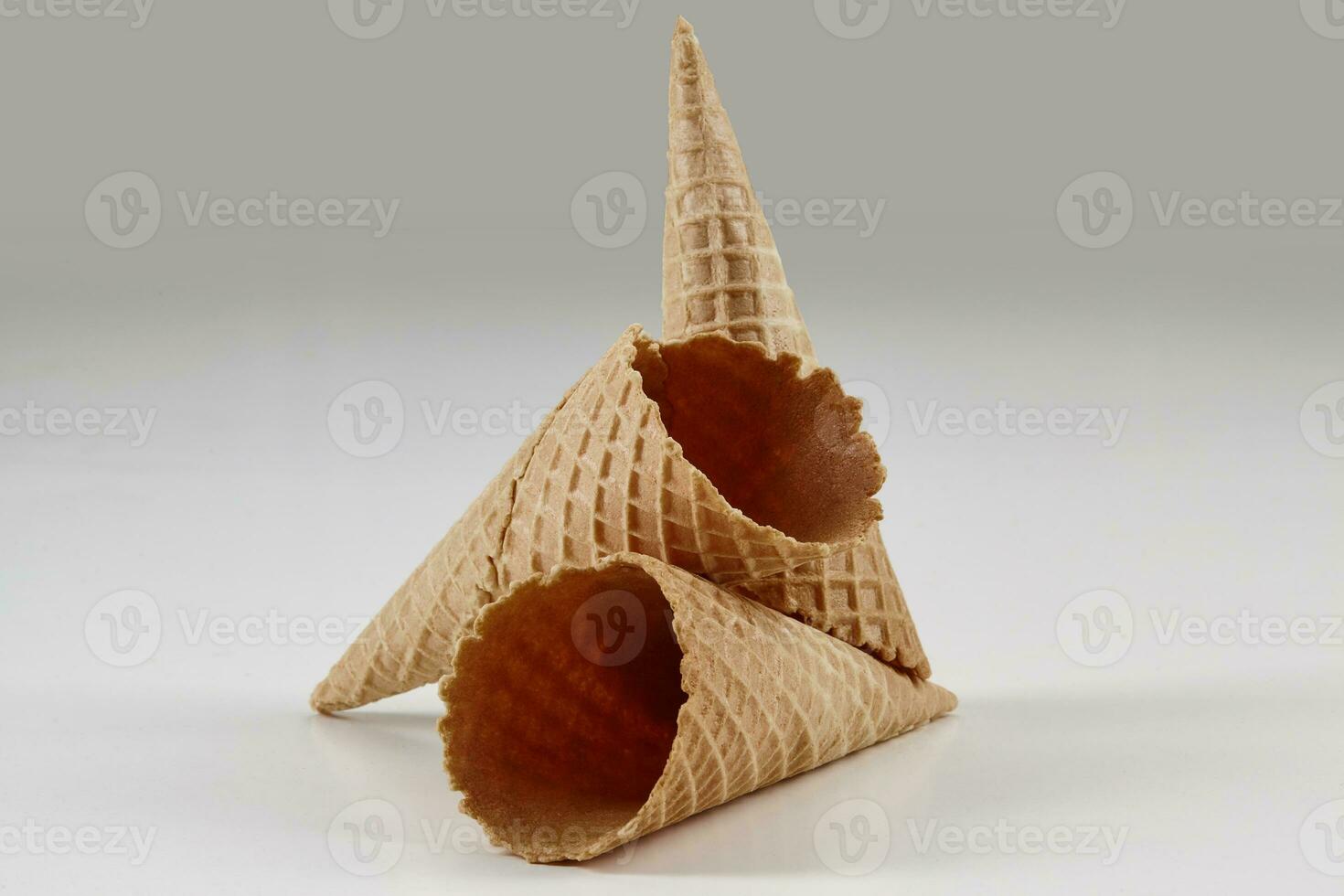 Two empty, crunchy wafer cones for ice cream isolated on white. Concept of food, treats. Mockup, template for your advertising and design. Close up photo