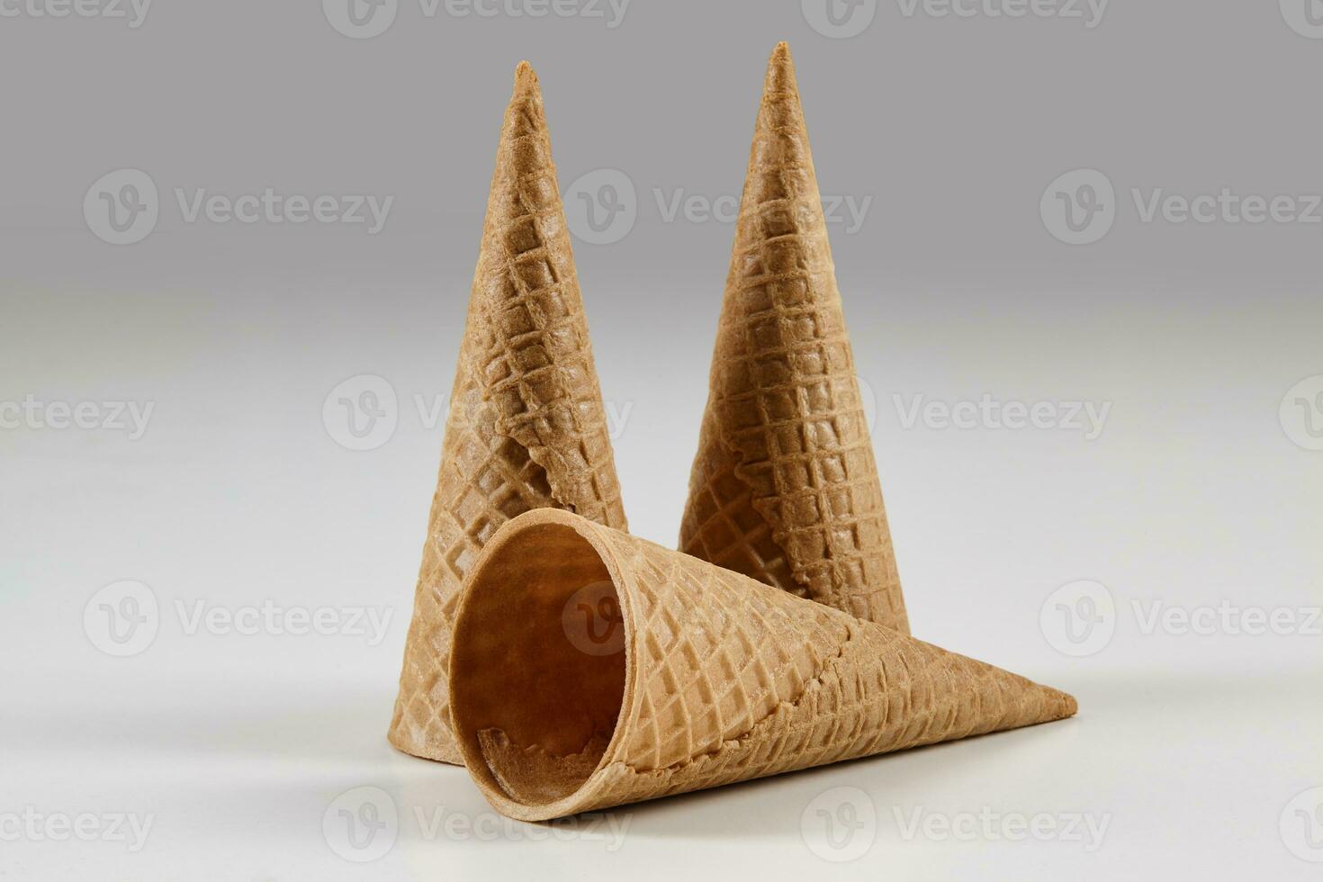 Three empty, big wafer cones for ice cream isolated on white. Concept of food, treats. Mockup, template for your advertising and design. Close up photo