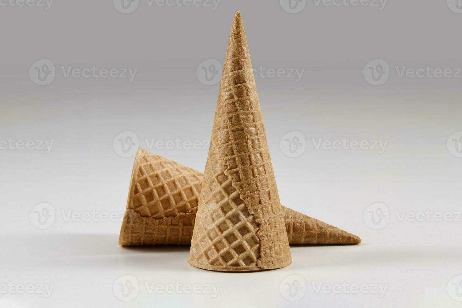 Two empty, big wafer cones for ice cream isolated on white. Concept of food, treats. Mockup, template for your advertising and design. Close up photo