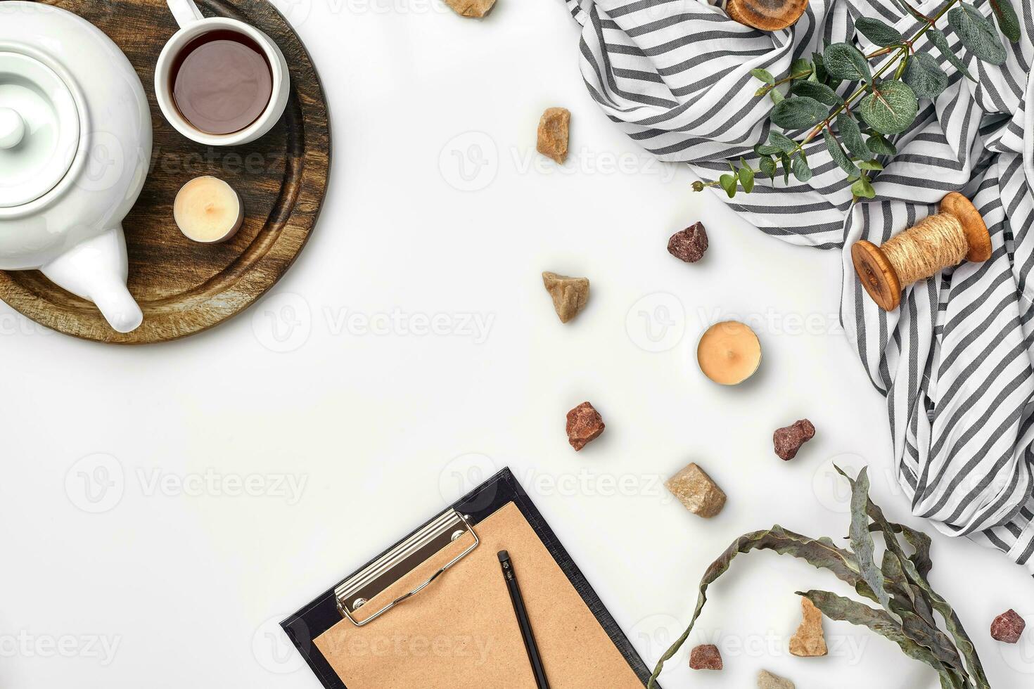 Opened diary with pen on the table near hot cup of black tea photo