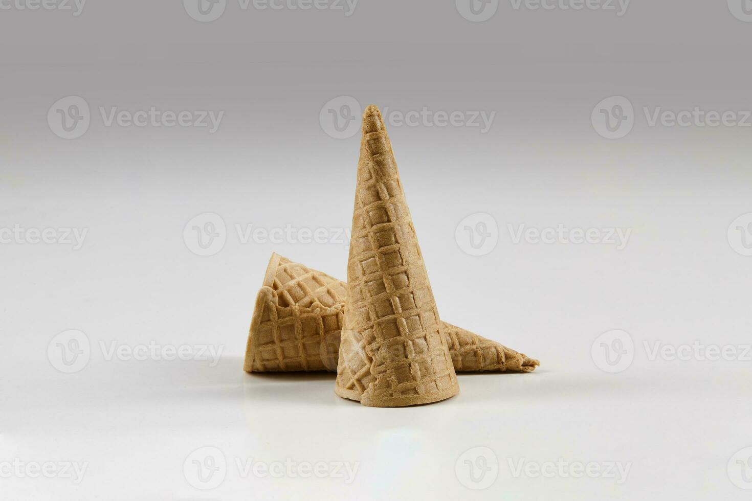 Two empty, small wafer cones for ice cream isolated on white. Concept of food, treats. Mockup, template for your advertising and design. Close up photo