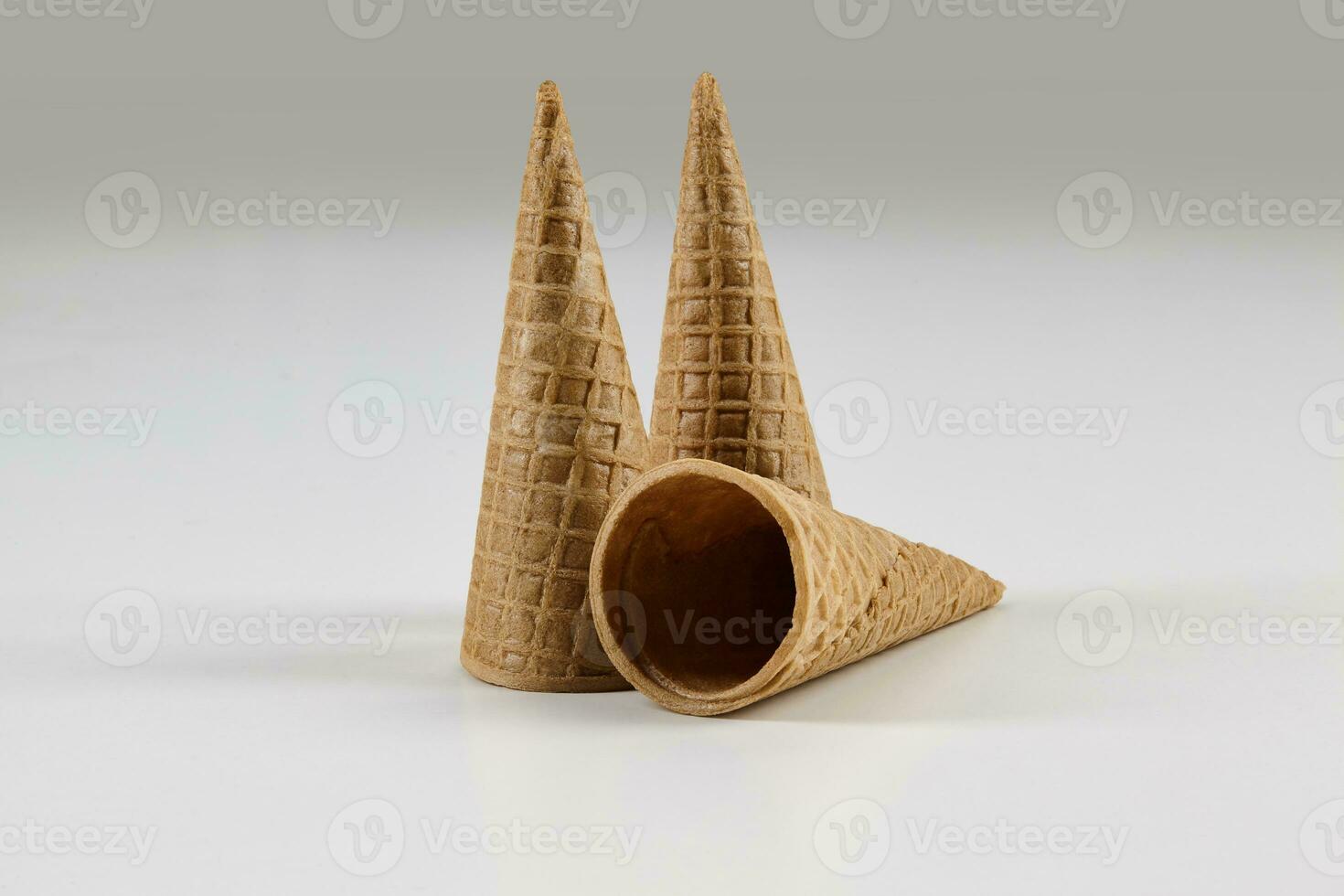 Three empty, medium wafer cones for ice cream isolated on white. Concept of food, treats. Mockup, template for your advertising and design. Close up photo