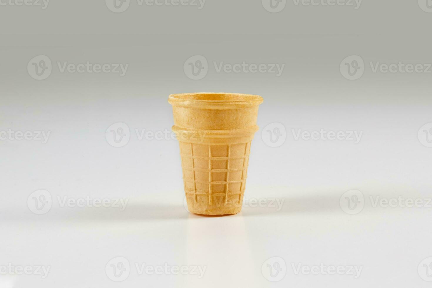 Empty, toasty wafer cup for ice cream isolated on white. Concept of food, treats. Mockup, template for your advertising and design. Close up photo