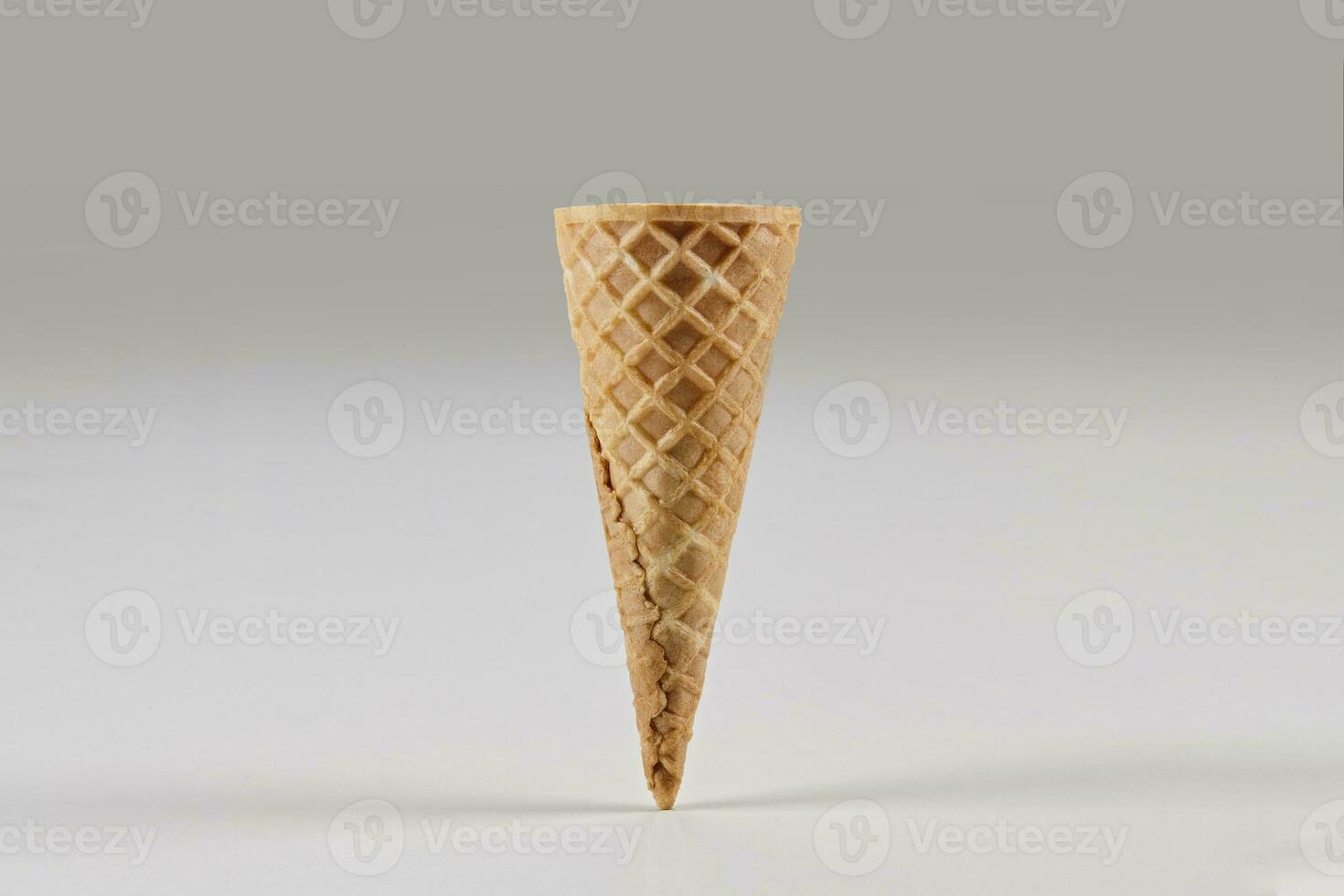 Empty wafer cone for ice cream isolated on white. Concept of food, treats. Mockup, template for your advertising and design. Close up photo