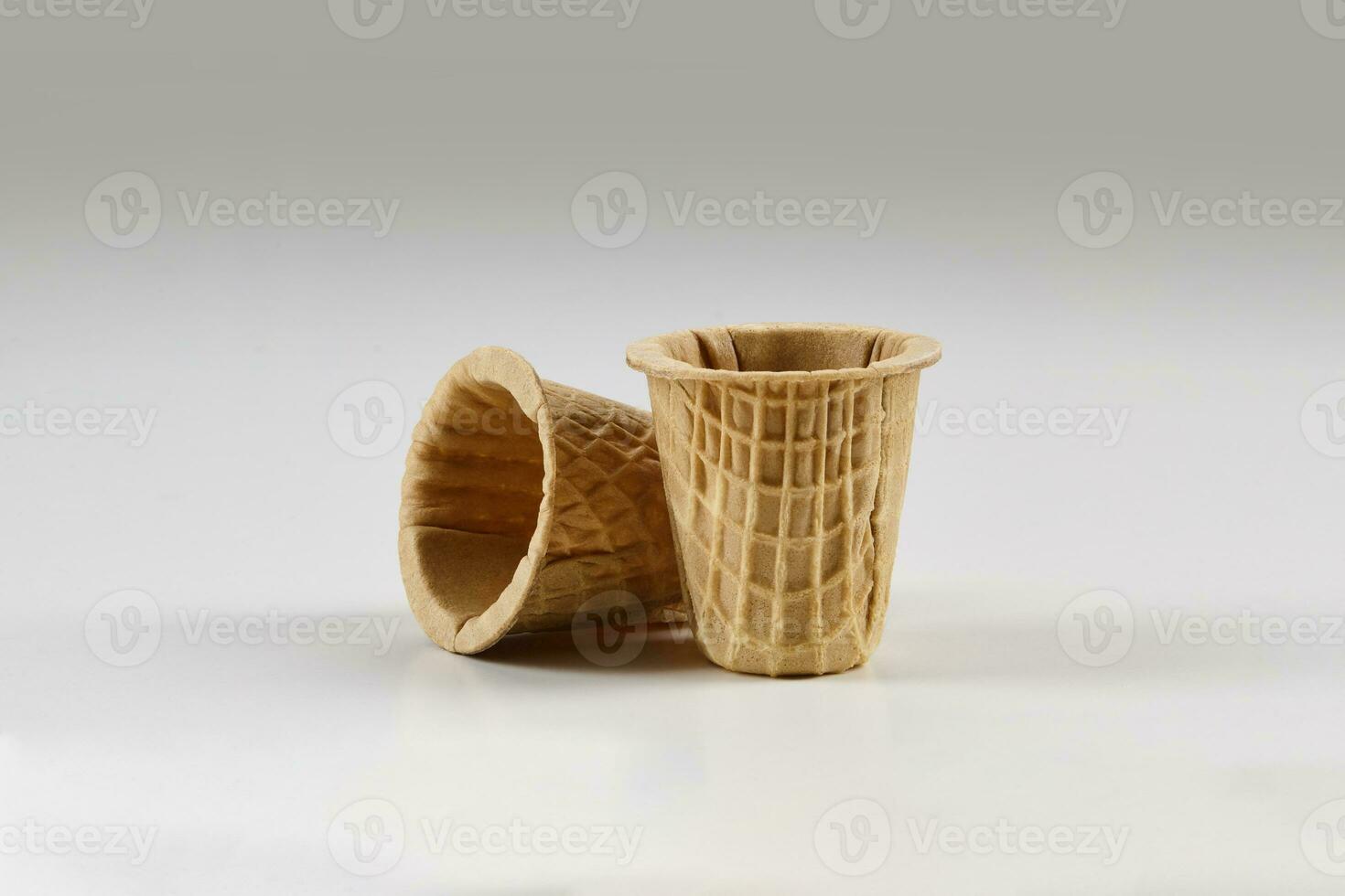 Two empty wafer cups for ice cream isolated on white background. Concept of food, treats. Mockup, template for your advertising and design. Close up photo