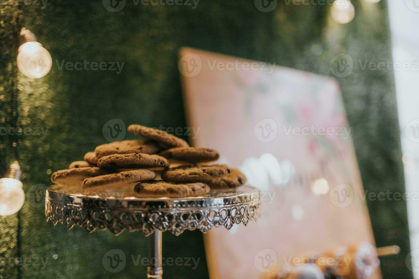 Close up of chocolate chip cookies on a cake stand in a cafe photo