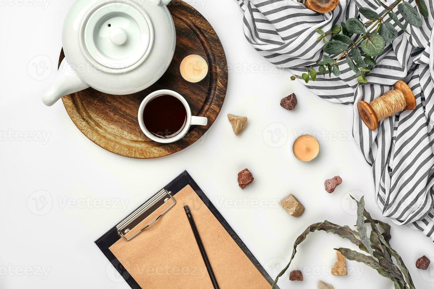 Opened diary with pen on the table near hot cup of black tea photo