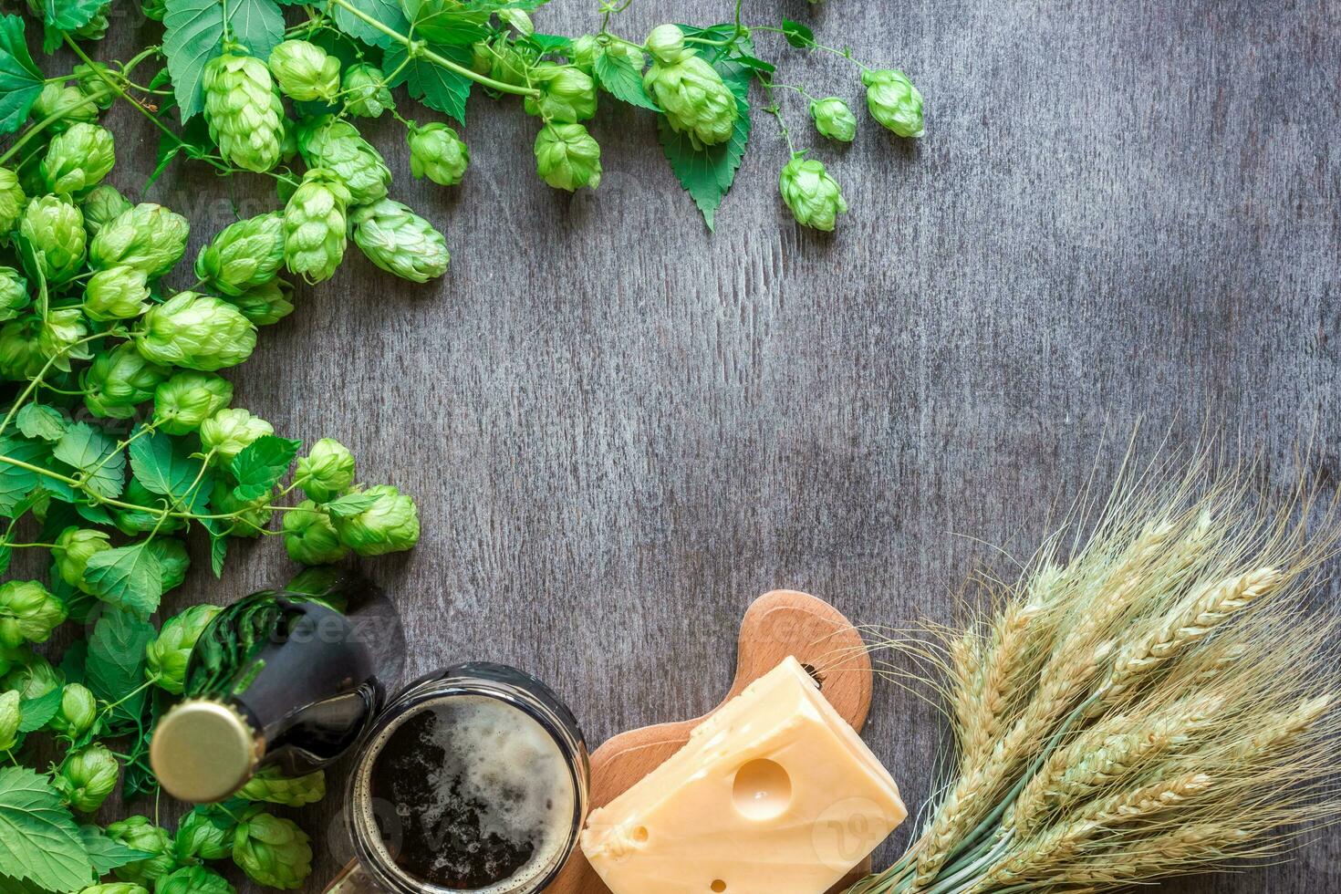 Beer background. Fresh beer and the salty cheese on a table. Top view photo