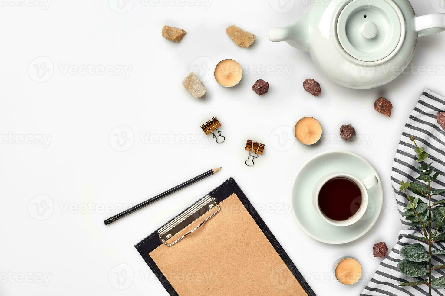 Opened diary with pen on the table near hot cup of black tea photo