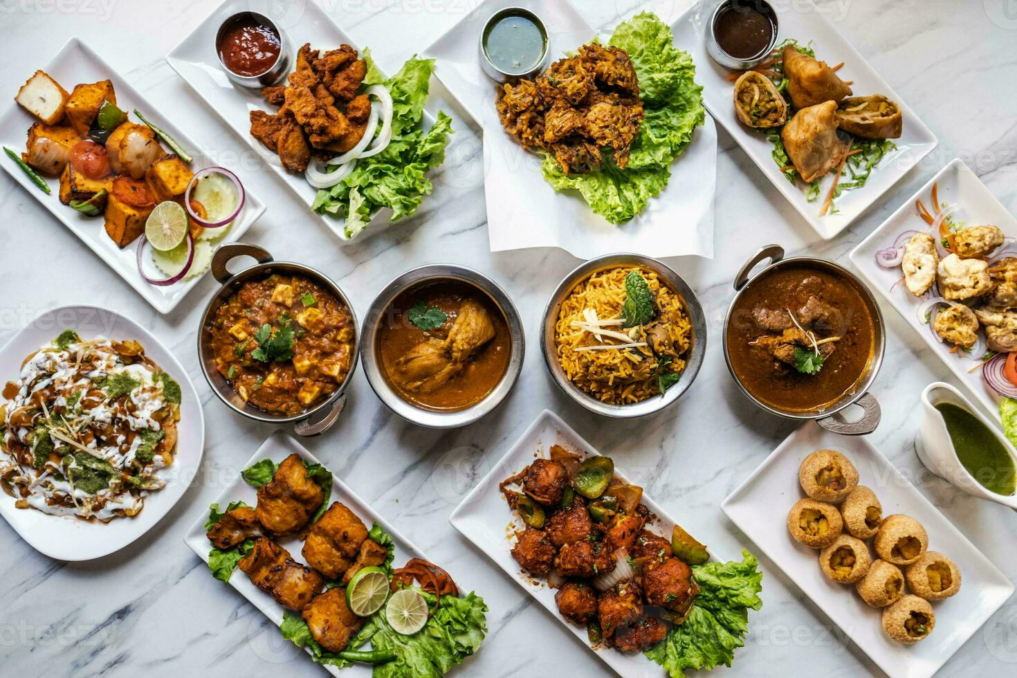 Group of Indian food includes chicken tikka masala, pakora or pakoda or pattice, aloo bhujiya, dahi vada, gathiya, aloo bhujiya, aloo bhujiya, dahi vada, aloo bhujiya, kaju, dahi vada photo