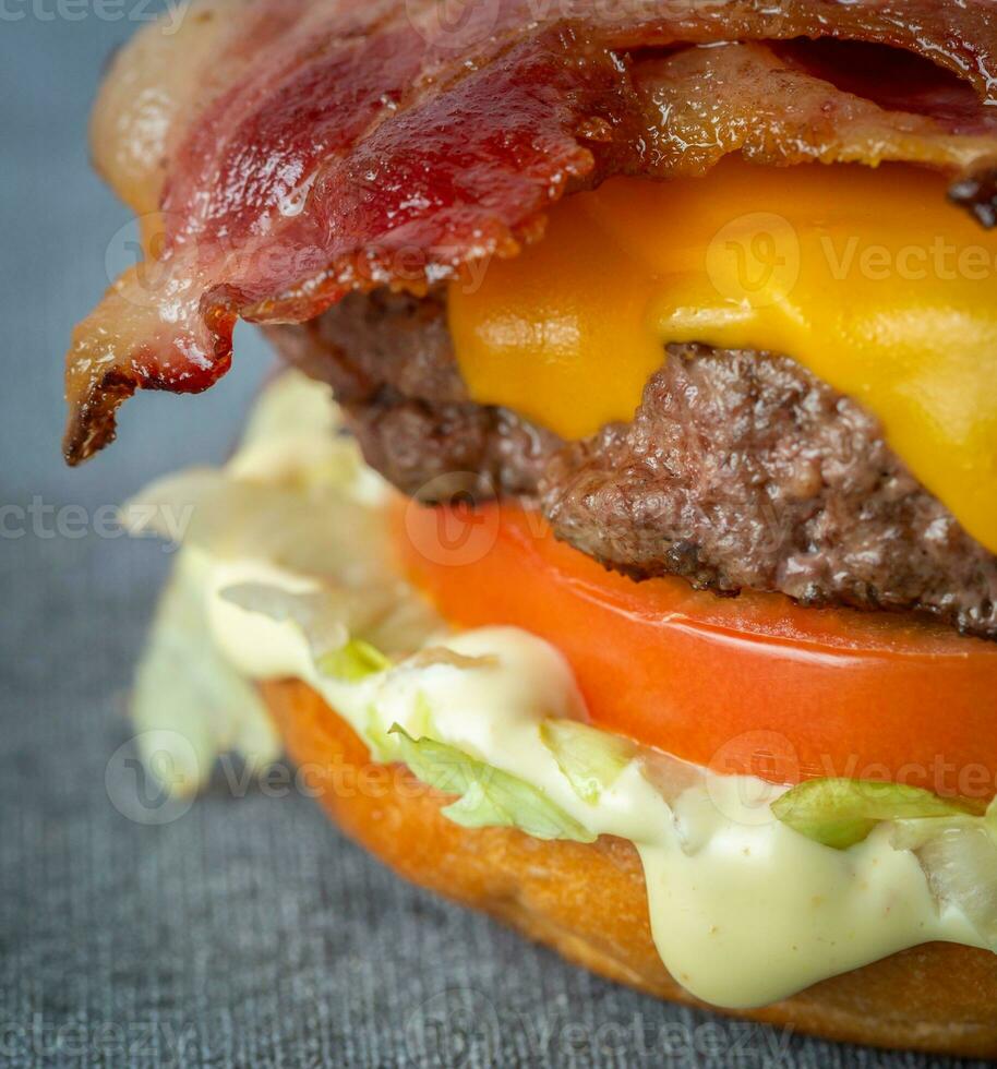 Cheese burger - American cheese burger with fresh salad and bacon. photo