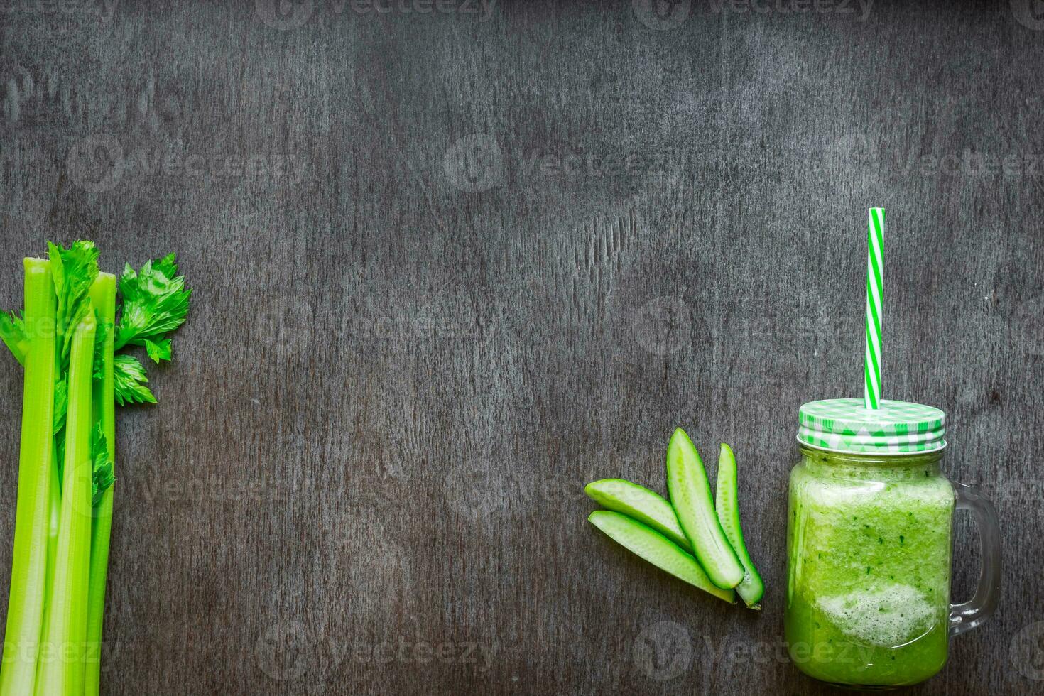Green vegetable smoothie with celery and cucumber photo