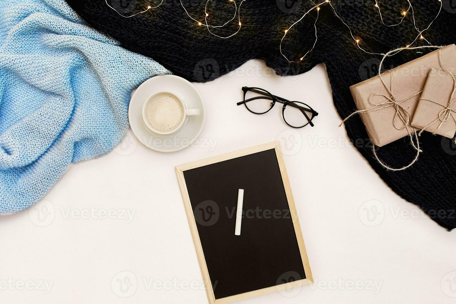 Autumn concept, dried fall leaves, mug of cocoa, old camera, scarf and wooden plank with blank screen. Mock up photo