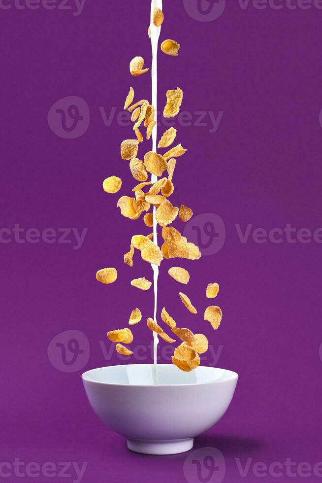 Falling granola with milk splash in bowl. Healthy breakfast ingredients. Flying food photo