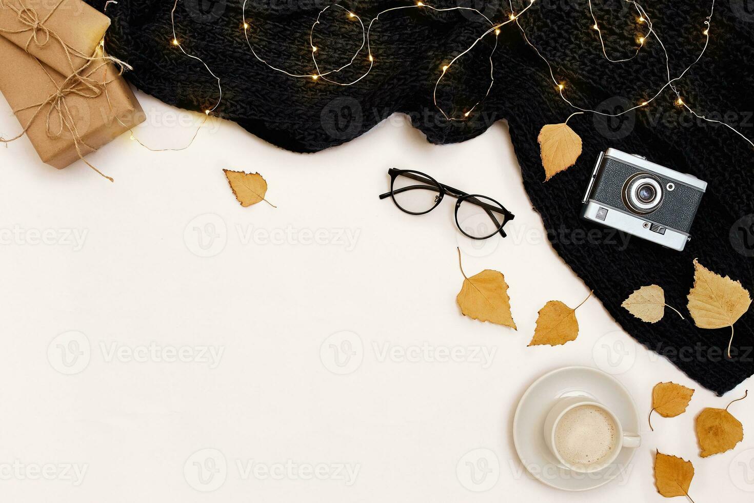 Autumn accessories for woman with yellow leaves and coffee with milk, top view photo