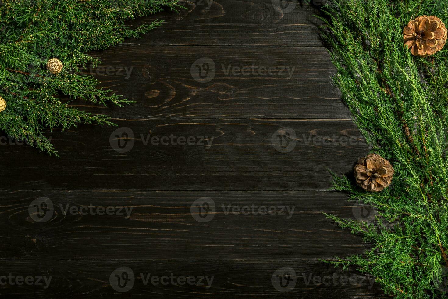 Fir branches border on black wooden background, good for christmas backdrop photo