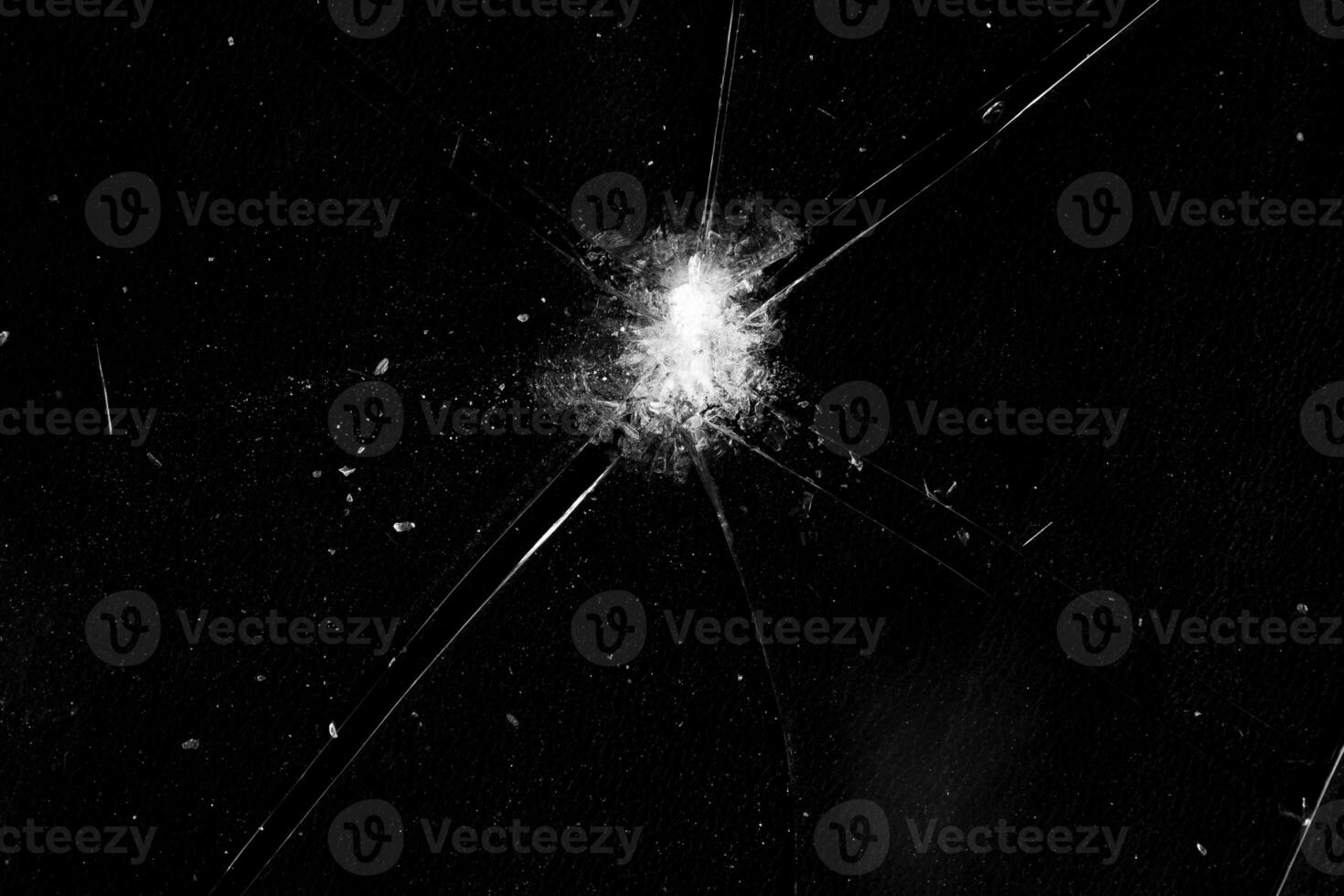 bullet hole with crack in glass photo