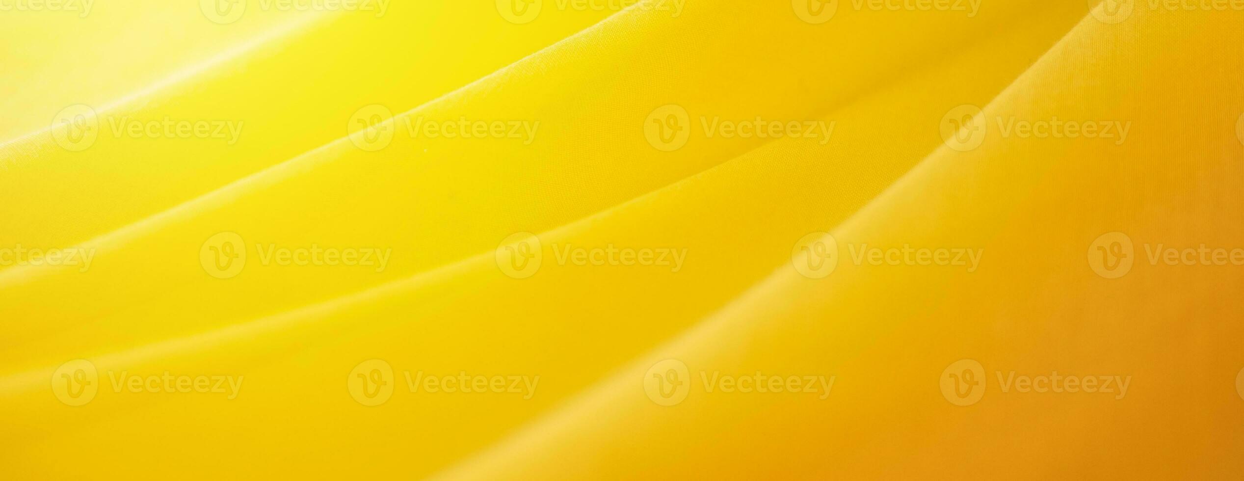 yellow silk background. Wave fabric banner copy space photo