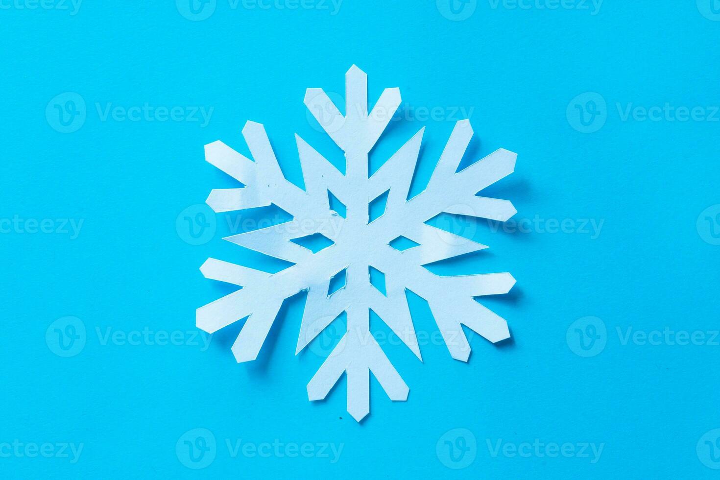 snowflake paper cut on blue background photo