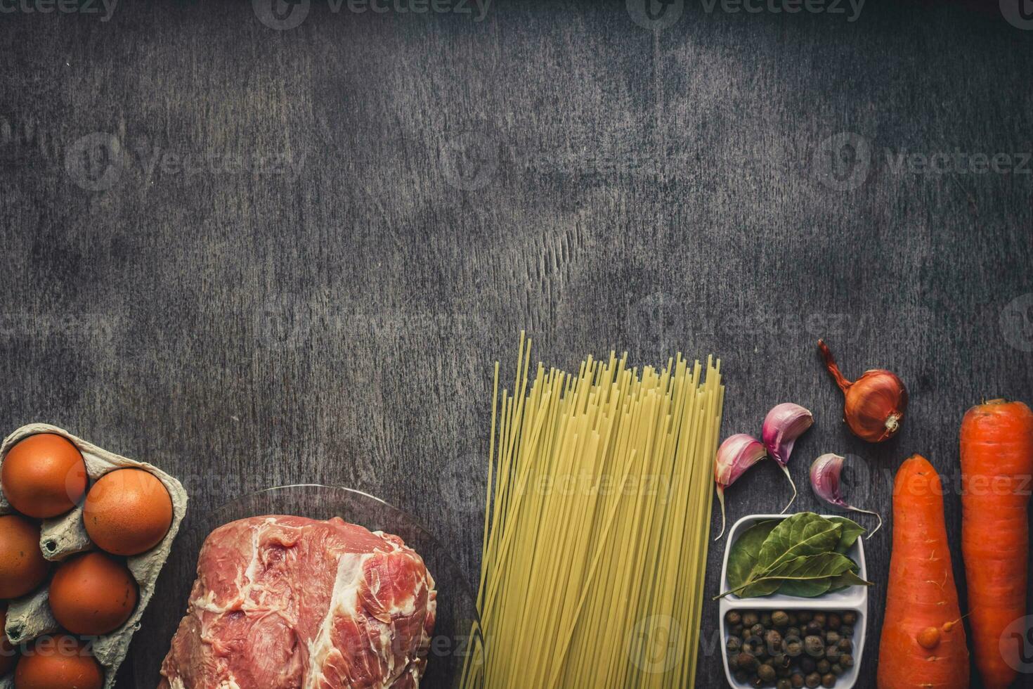 Raw meat beef with spaghetti, fresh organic vegetables, onion, garlic, spices, peppercorns, rosemary, salt and dill for cooking pasta. Top view. photo