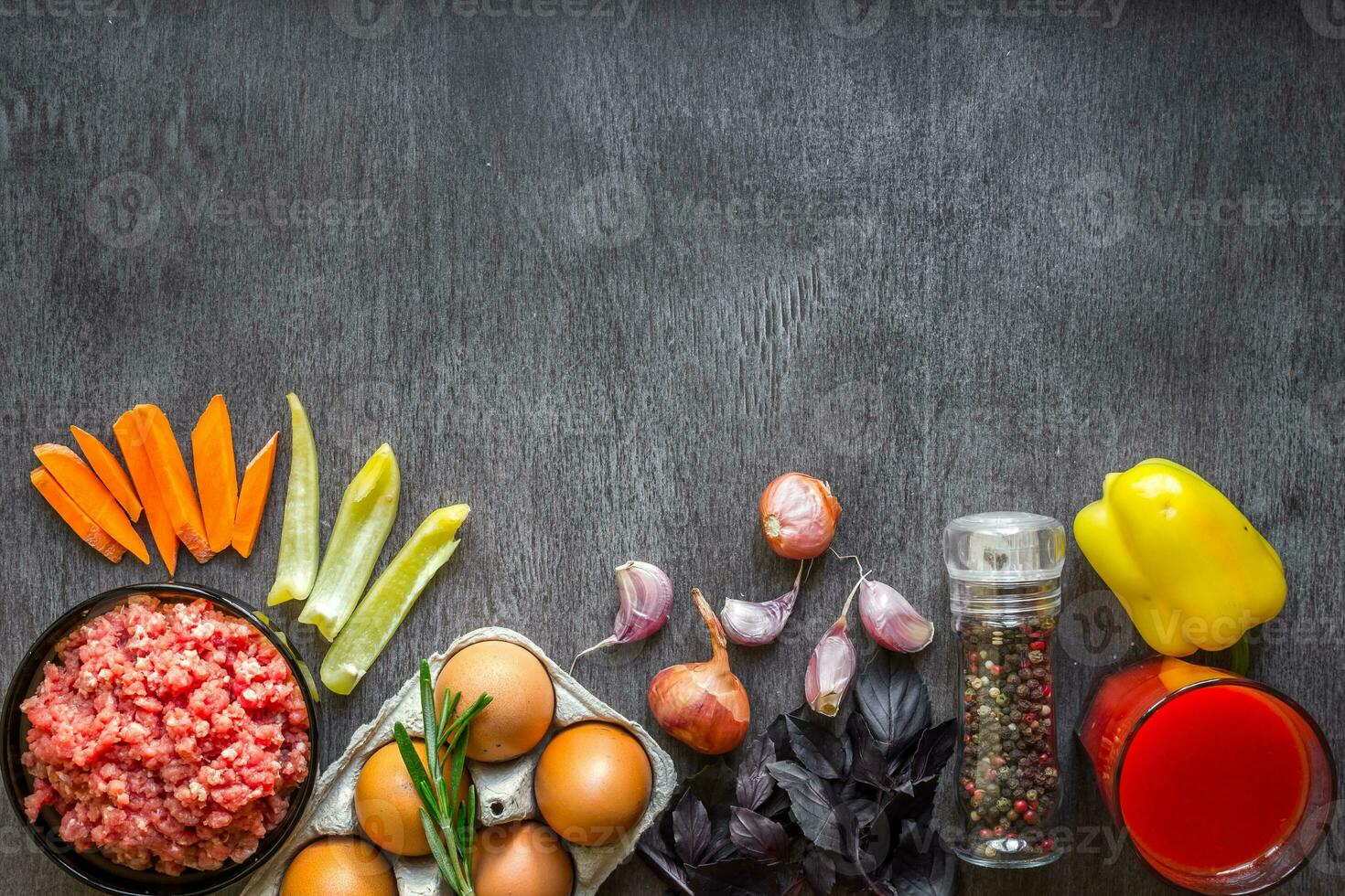 Composition of raw meat with vegetables and spice on wooden background photo